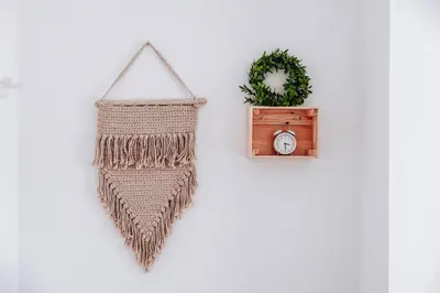 a rattan pendulum clock and a wreath on a wall at Villa Cerkniško jezero in Cerknica