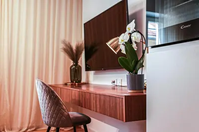 a room with a desk with a chair and a television at JU3 Apartments in Ljubljana