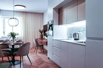 a kitchen with a table and a dining room at JU3 Apartments in Ljubljana
