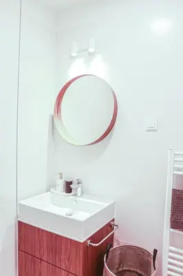 a bathroom with a sink and a mirror on the wall at JU3 Apartments in Ljubljana