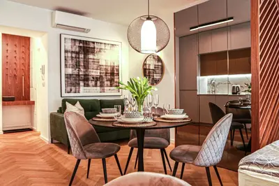 a dining room and living room with a table and chairs at JU3 Apartments in Ljubljana