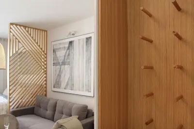 a living room with a couch and a mirror at JU3 Apartments in Ljubljana