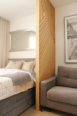 a bedroom with a bed and a chair at JU3 Apartments in Ljubljana