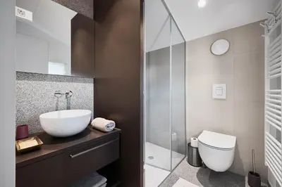 a bathroom with a sink and a toilet at Fine Rooms Vipava in Vipava