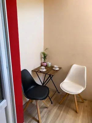 a small room with two chairs and a table at Room Julija in Žirovnica