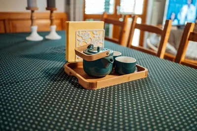 a tray with two cups and a tea set on a table at Cozy family place 'Hiša Grozdek' - Gruškovec 40A in Gruškovec