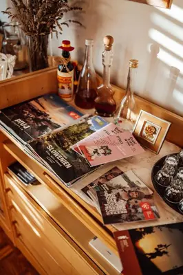 a counter with magazines and other items on it at Cozy family place 'Hiša Grozdek' - Gruškovec 40A in Gruškovec
