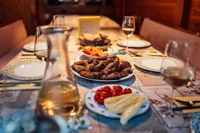 a table with plates of food and glasses of wine at Cozy family place 'Hiša Grozdek' - Gruškovec 40A in Gruškovec