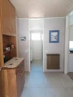 a kitchen with a counter and a door to a room at APARTMAJI VALTER in Srpenica