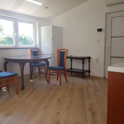 a dining room with a table and chairs in a room at Trg Mozirje in Mozirje