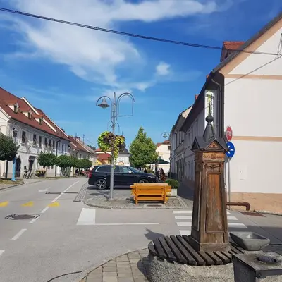 a street corner with a wooden pole in the street at Trg Mozirje in Mozirje