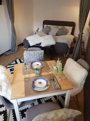 a dining room with a table and a bed at A place to relax in Ljubljana