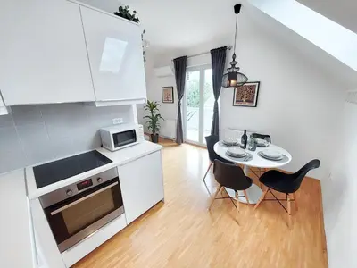a kitchen with a table and chairs and a microwave at Centrally located, with castle view and 2 parkings in Bled
