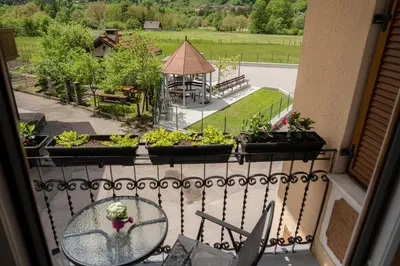 a balcony with a view of a garden and a gazebo at Relax House Soča in Bovec