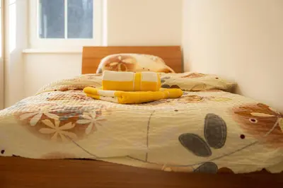 a bed with a book and a stuffed animal on it at Relax House Soča in Bovec
