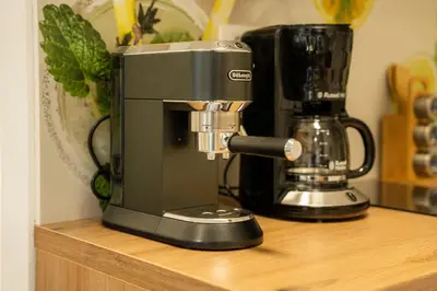 a black coffee maker sitting on a wooden shelf at Relax House Soča in Bovec