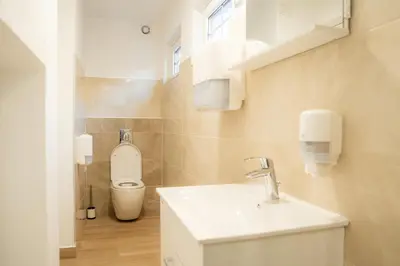 a bathroom with a sink and a toilet at Relax House Soča in Bovec