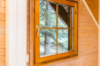 a window in a log cabin with a tree at Chalet Liza & Rozi in Zgornja Ložnica