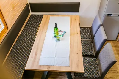 a table in a box with a bottle of beer on it at Chalet Liza & Rozi in Zgornja Ložnica