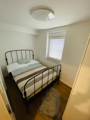 a bedroom with a bed and a window at Gogalova Apartments in Ljubljana