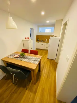 a kitchen and dining room with a table and a refrigerator at Gogalova Apartments in Ljubljana