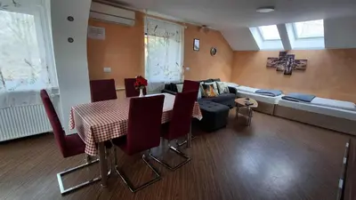 a living room with a table and a couch at Hiša Bizjak in Kranj