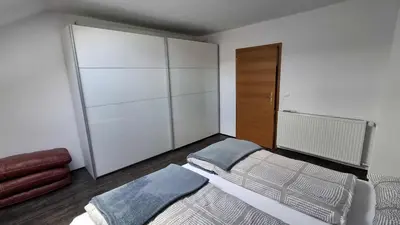 a bedroom with a bed and a closet at Hiša Bizjak in Kranj