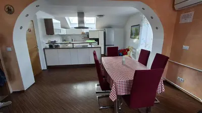 a kitchen and dining room with a table and chairs at Hiša Bizjak in Kranj