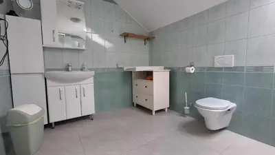 a bathroom with a sink and a toilet at Hiša Bizjak in Kranj
