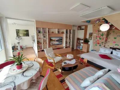 a living room with a bed and a table at Apartma Velesa in Rače