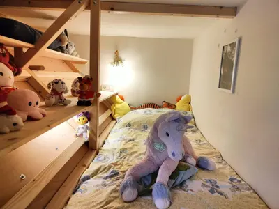 a bedroom with a bunk bed with stuffed animals on the floor at Apartma Velesa in Rače