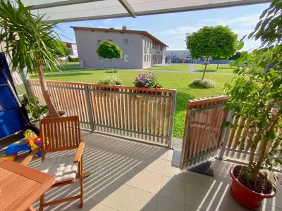 a patio with a fence and a table and chairs at Apartma Velesa in Rače