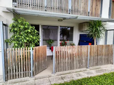 a wooden fence in front of a house at Apartma Velesa in Rače