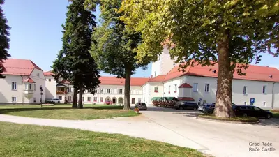 a large white building with a red roof at Apartma Velesa in Rače