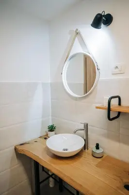 a bathroom with a sink and a mirror at Štekner house Apartma in Ljubno