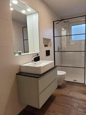 a bathroom with a sink and a toilet and a mirror at Apartment river Nadiža Podbela in Podbela