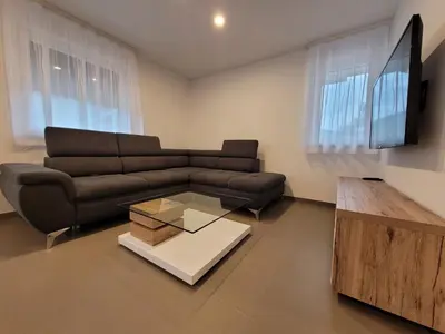 a living room with a couch and a coffee table at Apartment river Nadiža Podbela in Podbela