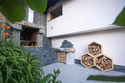 a pile of fire wood next to a building at Vineyard cottage Sonce in Šentvid pri Stični
