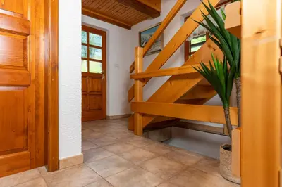 a wooden staircase in a house with a potted plant at Chalet Ajda in Bohinj
