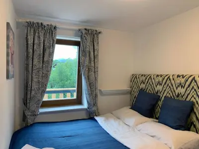 a bedroom with a bed and a window at NUMBER 10 Apartments in Bled