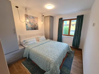 a bedroom with a bed and a window at NUMBER 10 Apartments in Bled