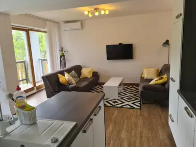 a living room with couches and a flat screen tv at NUMBER 10 Apartments in Bled