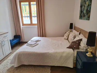 a bedroom with a bed and a window at NUMBER 10 Apartments in Bled