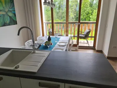 a kitchen with a sink and a counter with a table at NUMBER 10 Apartments in Bled