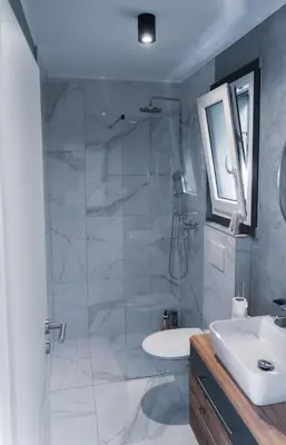 a bathroom with a shower and a sink at Mobilna hiška pod Lipo in Velenje