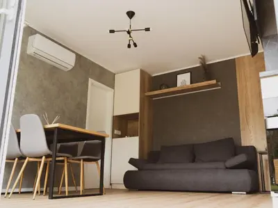 a living room with a couch and a table at Mobilna hiška pod Lipo in Velenje