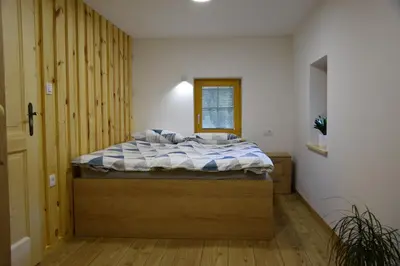 a bedroom with a large bed in a room at Valle Divina in Mislinja