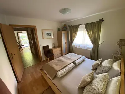 a bedroom with a large bed with pillows on it at Villa СARPE DIEM in Laško