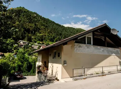 a house with a mountain in the background at Villa СARPE DIEM in Laško