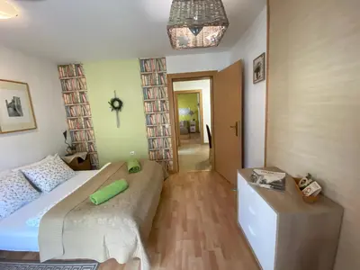 a small bedroom with two beds and a hallway at Villa СARPE DIEM in Laško